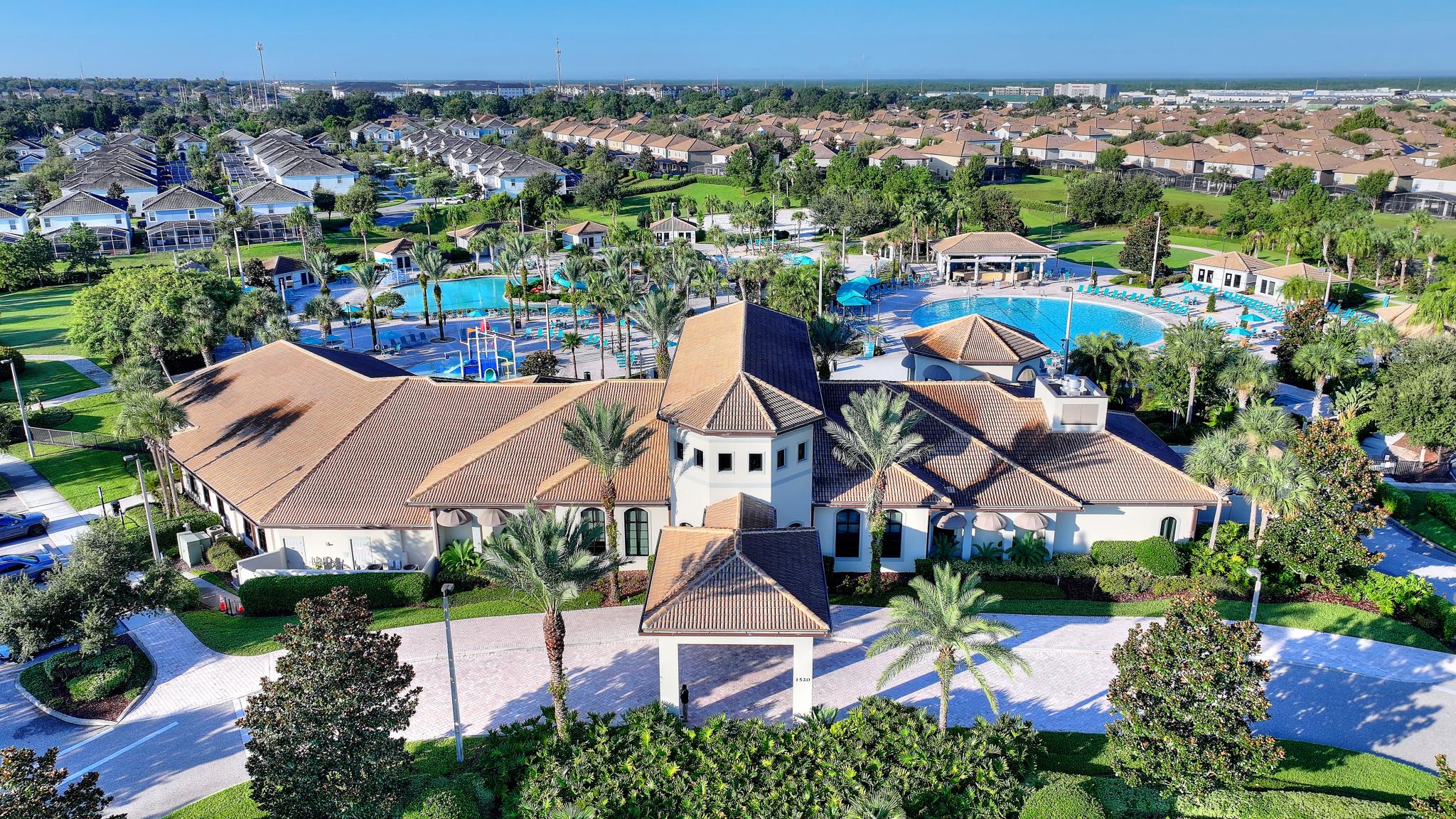 Aerial view of the Oasis Club clubhouse and surrounding pool complex