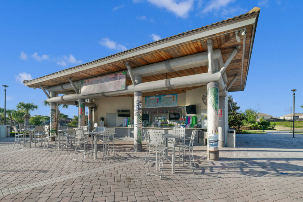 The Oasis Club tiki bar with outdoor tables and Oasis signage